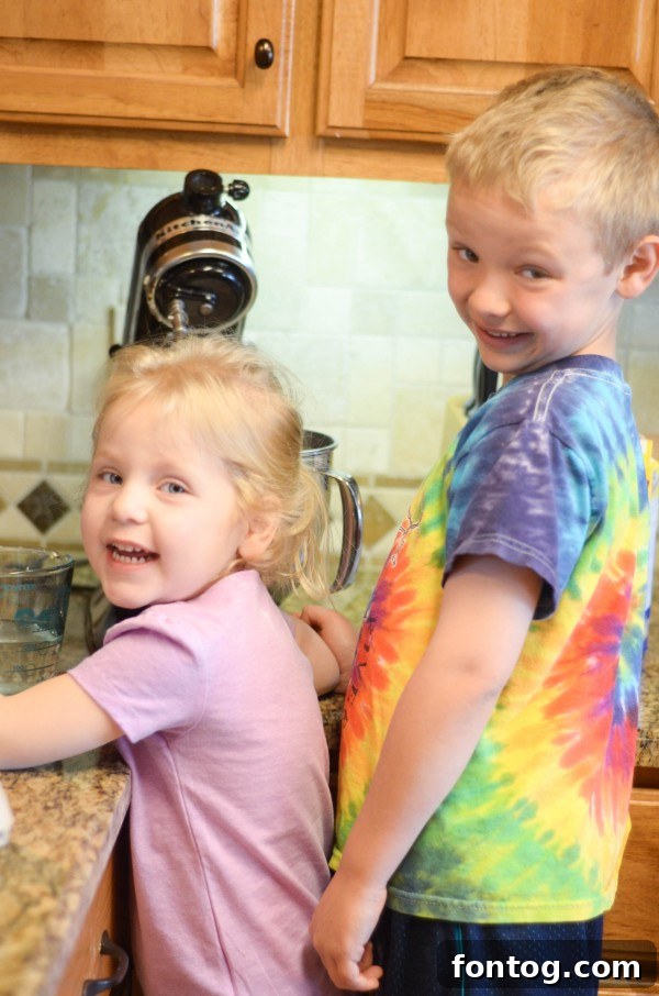Fresh Bloom Cupcakes 6 A close-up shot of small hands carefully placing colorful sprinkles onto a freshly frosted Spring Cupcake, adding a final touch.