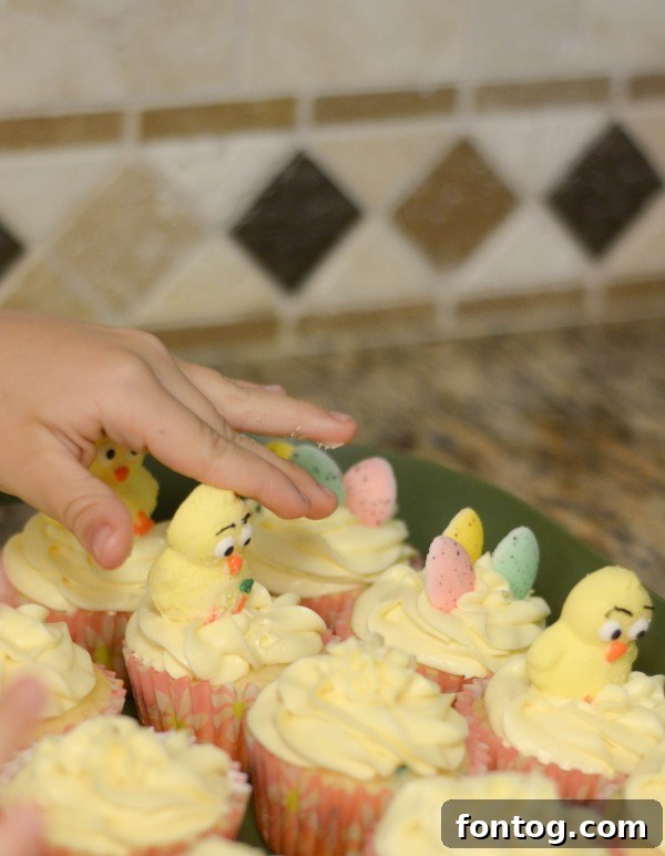 Fresh Bloom Cupcakes 10 Hands carefully arranging beautifully decorated Spring Cupcakes on a serving tray, adorned with delicate spring decorations and colorful toppings.