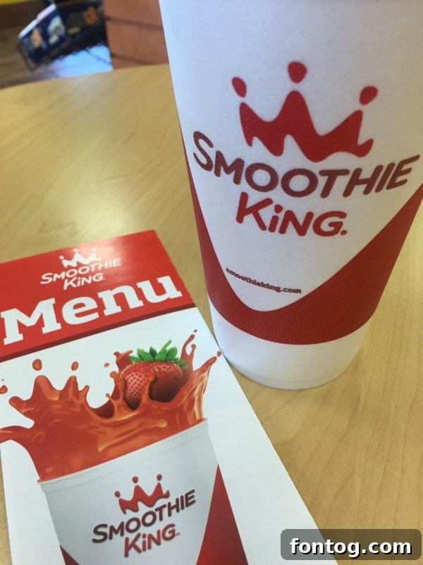 Closeup of an Apple Kiwi Kale Smoothie, a delicious and healthy choice from Smoothie King for #BlendMoreVeggies.