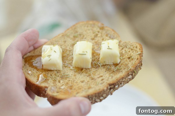 Honey and Brie cheese toast on Pepperidge Farm Harvest Blends bread, drizzled with honey.