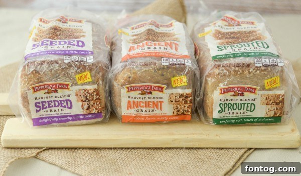Close-up of a Rosemary Chicken Salad sandwich on Pepperidge Farm Harvest Blends bread, showcasing its hearty texture.