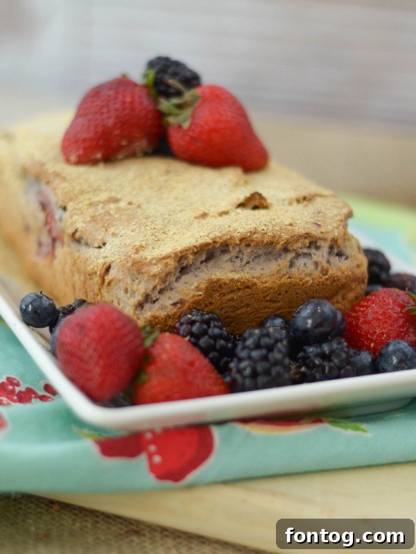 A slice of Berry Oatmeal Bread artfully placed on a plate, ready to be enjoyed as a snack or breakfast item.