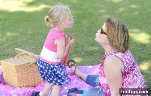 A mother and daughter sharing a sweet embrace during their Minnie Mouse themed picnic. #PreciousMoments #FamilyBonding