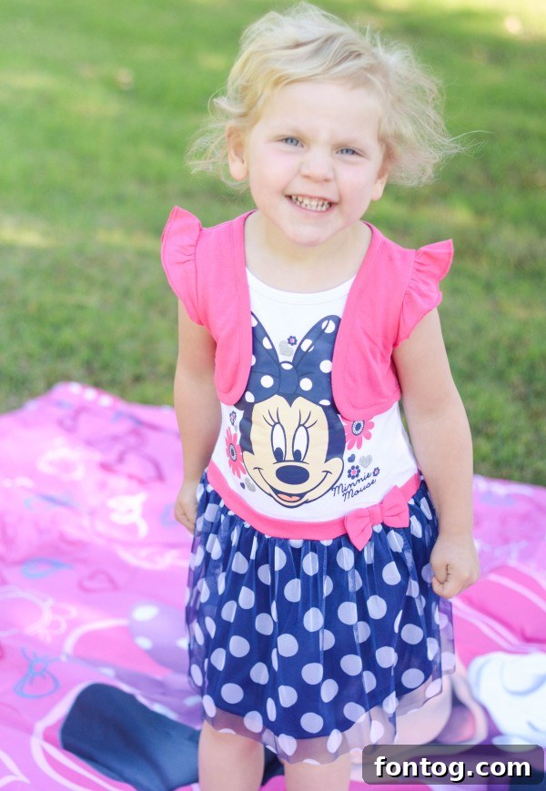 The happy family, including mother, daughter in Minnie Mouse dress, and son, enjoying a fun-filled day. #FamilyFun #DisneyWeekend