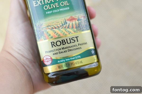 Pompeian Robust Extra Virgin Olive Oil on a wooden board