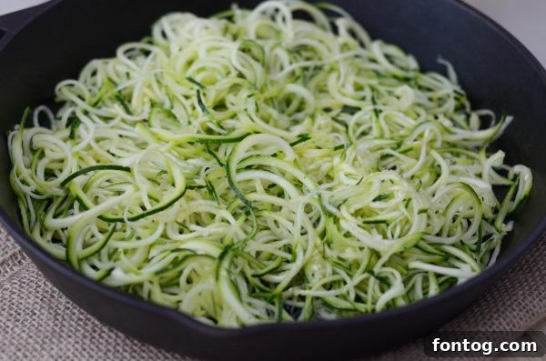 Finished Cheesy Baked Zoodles in a skillet, ready to serve