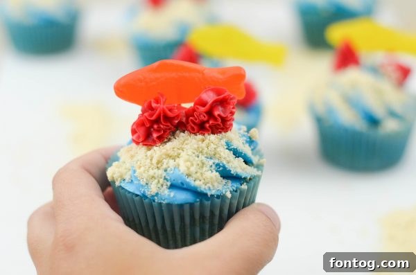 Ocean Friends Cupcakes - Displayed on a cake stand, showcasing their blue and sandy appearance