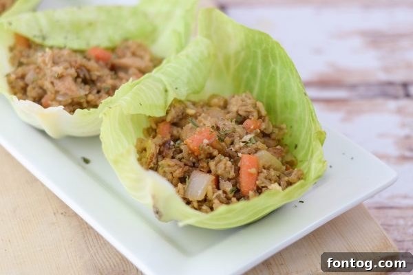 Bowl of chicken and rice filling next to softened cabbage leaves