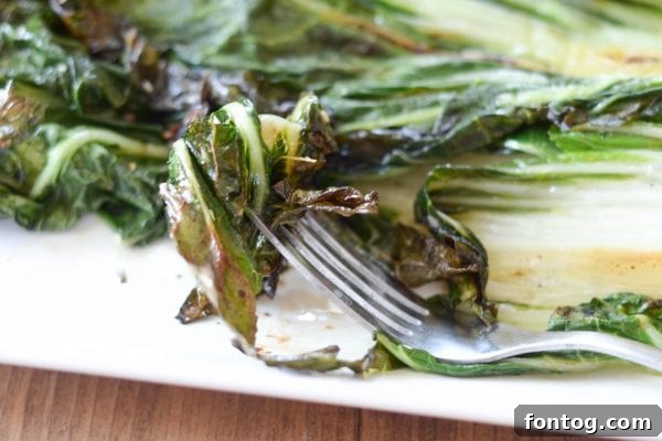 Fresh Bok Choy, sliced lengthwise and ready for grilling, drizzled with an Asian-inspired sauce