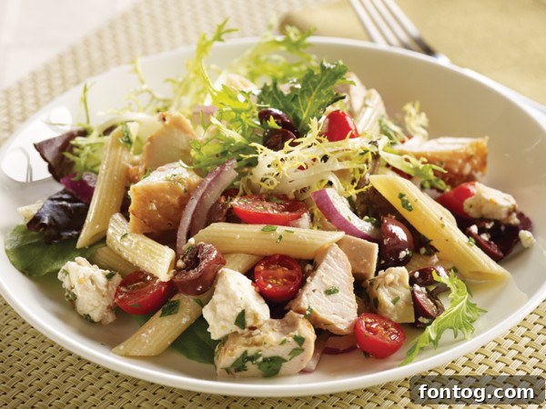 Vibrant Mediterranean Turkey Pasta Salad in a large serving bowl, garnished with fresh herbs, ready for a summer cookout.