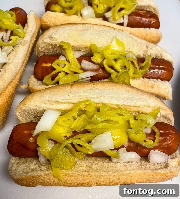 Grilled sausage links with melty cheese and toppings