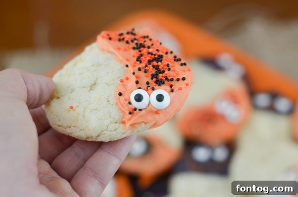 Spooky Sugar Cookies - Various Halloween sugar cookies, some with colorful sprinkles and others with candy eyeballs, on a serving tray.