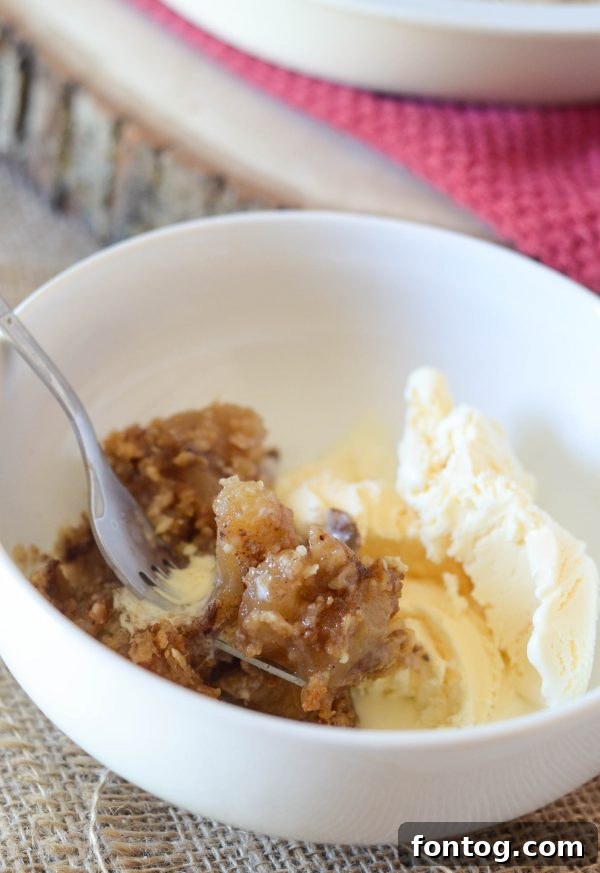 Scoops of gluten-free caramel apple crisp served with vanilla ice cream