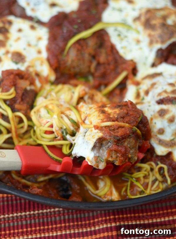 Baked Zoodles and Meatballs with melted mozzarella cheese.