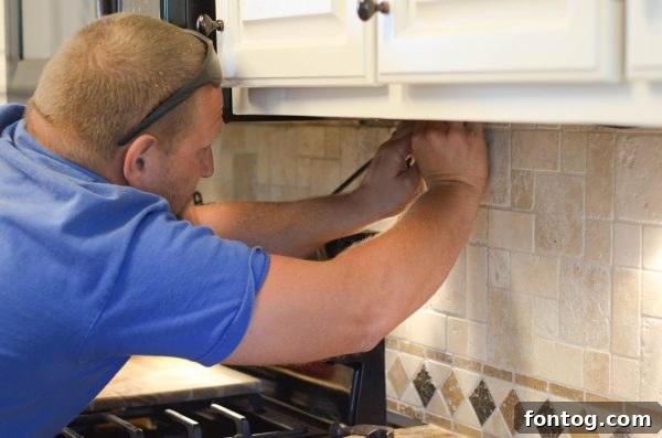 Enbrighten Cafe String Lights installed under kitchen cabinets, providing soft illumination