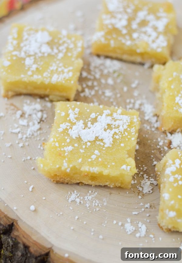 A batch of Old Fashioned Lemon Bars, dusted with powdered sugar, ready to serve