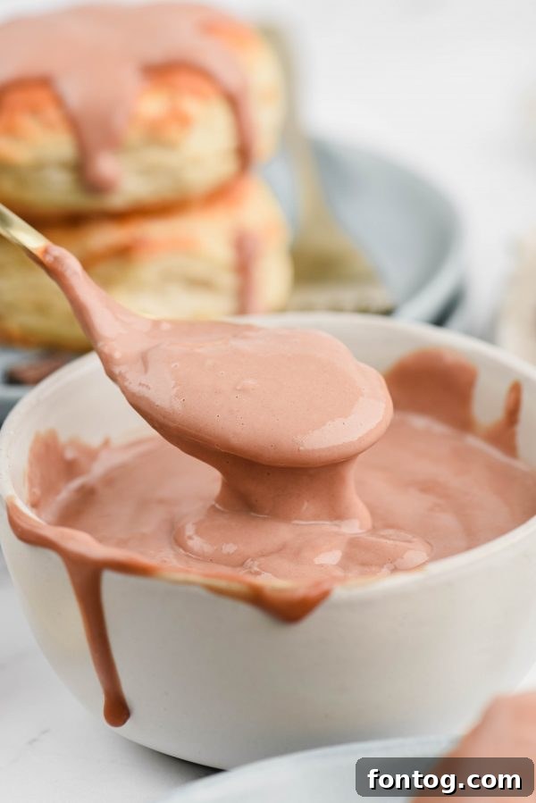 A bowl of chocolate gravy garnished with fresh berries.