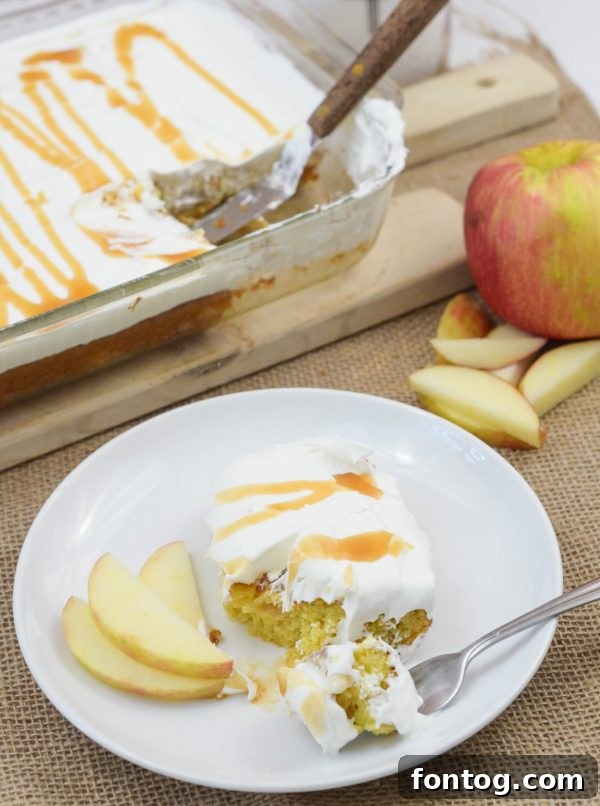 Whole Caramel Apple Cake decorated with whipped cream and caramel drizzle