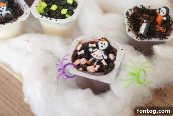 Pudding cups decorated as a skeleton graveyard with bone cookies