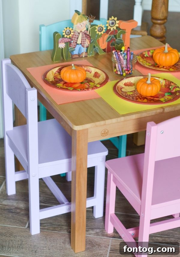 A child happily seated at a KidKraft Farmhouse Table, enjoying the kid-sized furniture.