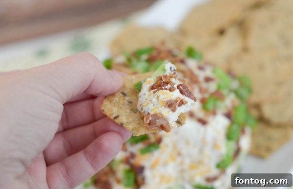 Close-up of Bacon Ranch Cheese Ball, highlighting the bacon and green onion coating