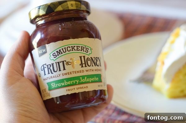 Two slices of Strawberry Jalapeño Cream Cheese Poke Cake on a plate