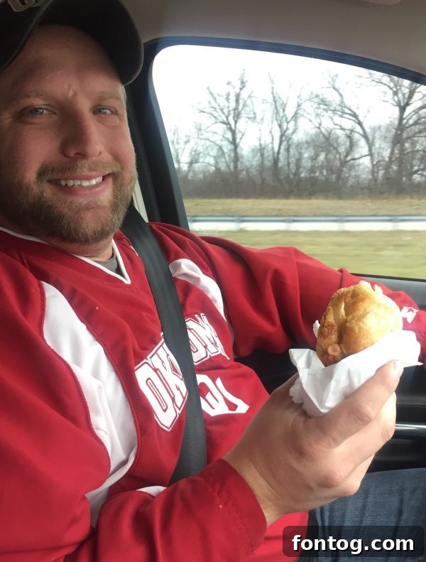Author enjoying Dunkin' coffee on a road trip, emphasizing the need for caffeine while traveling