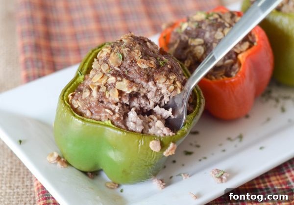 Three Meatloaf Stuffed Peppers cooling on a baking sheet, showcasing their golden-brown tops