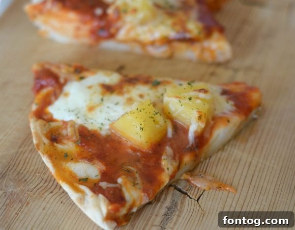 Slices of Deep Dish Hawaiian Pizza ready to serve