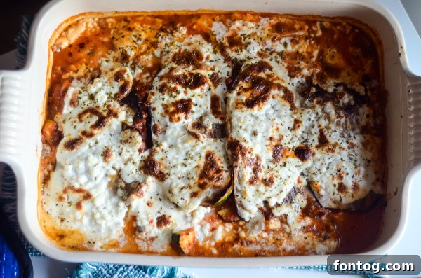 roasted eggplant slices cooling on a baking sheet
