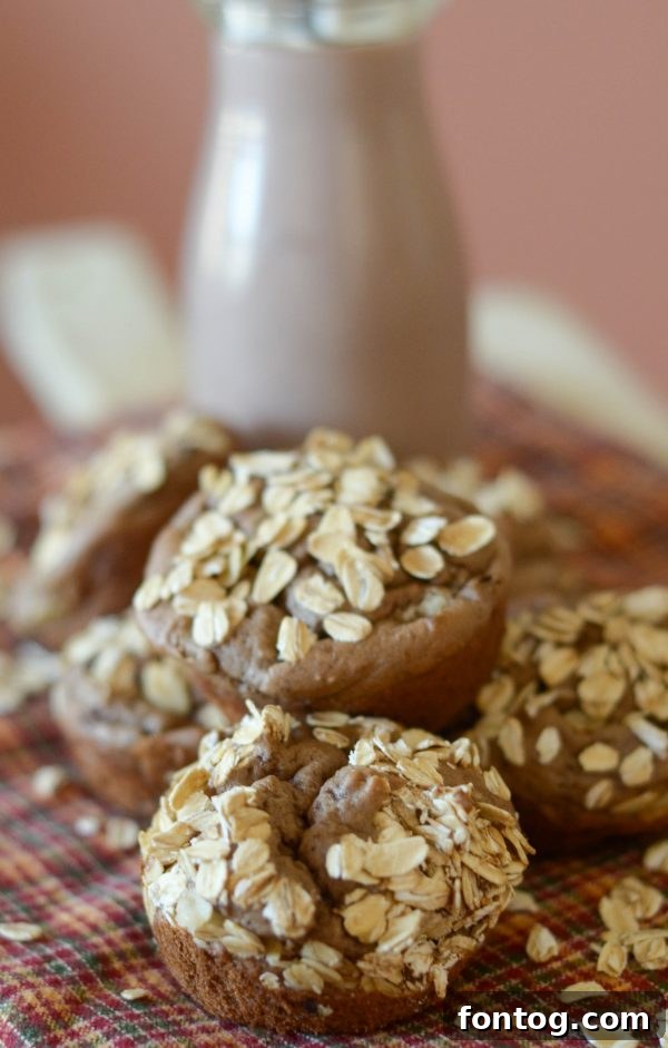 A collection of warm, freshly baked Chocolate Banana Muffins arranged appealingly on a cooling rack.