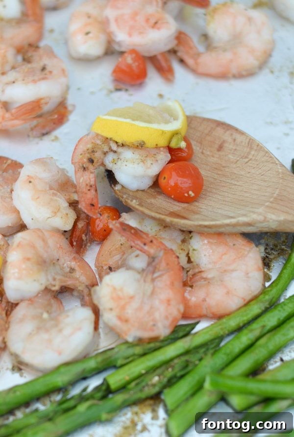 Sheet Pan Lemon Garlic Shrimp - A vibrant and healthy low-carb dinner idea featuring succulent shrimp, crisp asparagus, and juicy grape tomatoes, all infused with bright lemon and savory garlic flavors. Naturally gluten-free and incredibly easy to prepare.