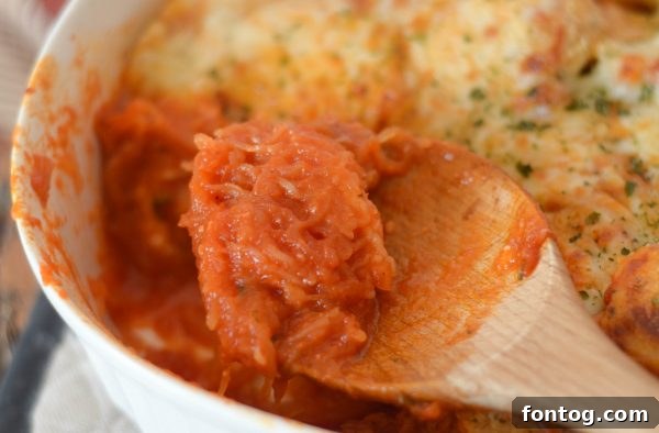 Wholesome Chicken Parmesan with Spaghetti Squash 4 A serving of Chicken Parmesan with Spaghetti Squash on a plate, garnished with fresh parsley