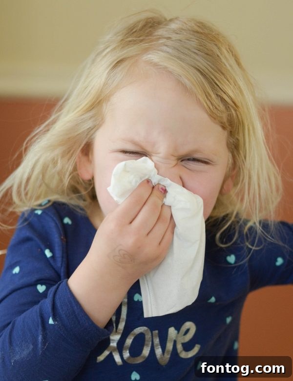 A child using Kleenex Anti-Viral tissues to prevent germ spread