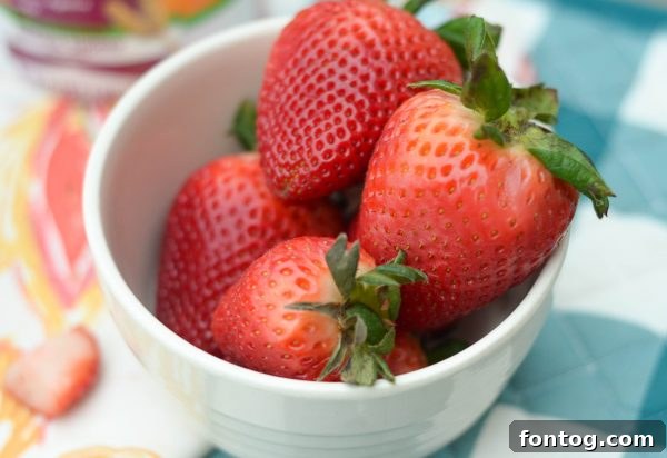 Close-up of a perfectly blended strawberry smoothie in a glass jar, demonstrating a refreshing and healthy beverage.