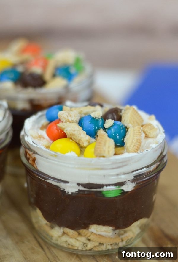 M&MS Caramel Cookie Parfaits: Indulge and Win 7 Close-up of a spoon digging into the creamy layers of an M&M'S® Caramel Cookie Parfait.