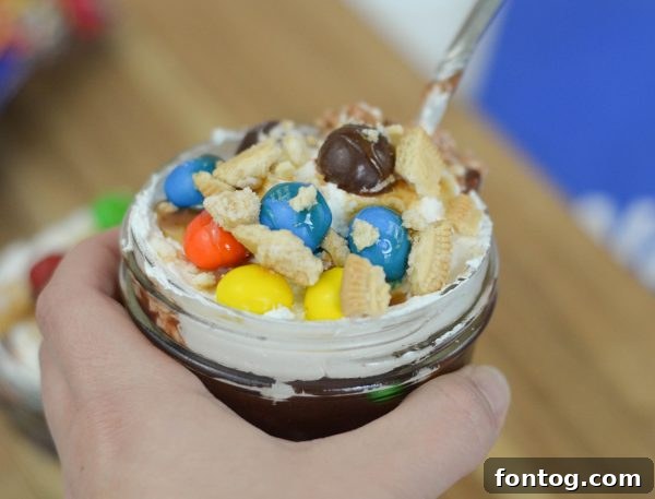 M&MS Caramel Cookie Parfaits: Indulge and Win 8 A finished M&M'S® Caramel Cookie Parfait, beautifully presented in a glass, with a spoon ready for the first bite.