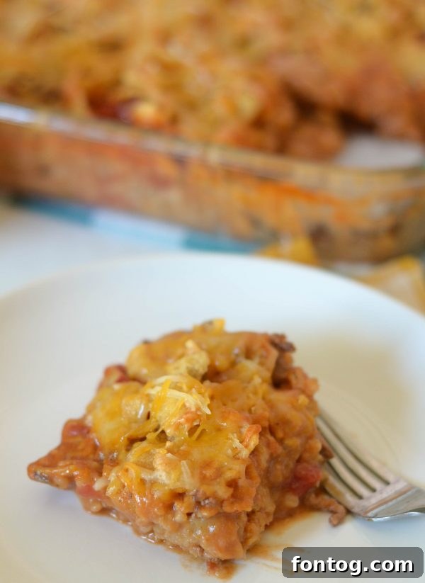 Close-up of a generous serving of Mexican Meatloaf Casserole, garnished with fresh cilantro.