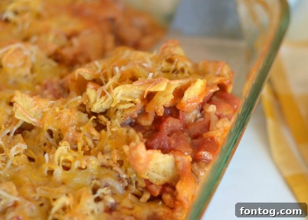 Freshly baked Mexican Meatloaf Casserole, topped with perfectly melted cheese and crispy Fritos.