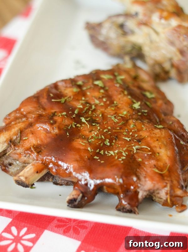 Close-up of Instant Pot Maple Glazed Ribs on a plate with corn