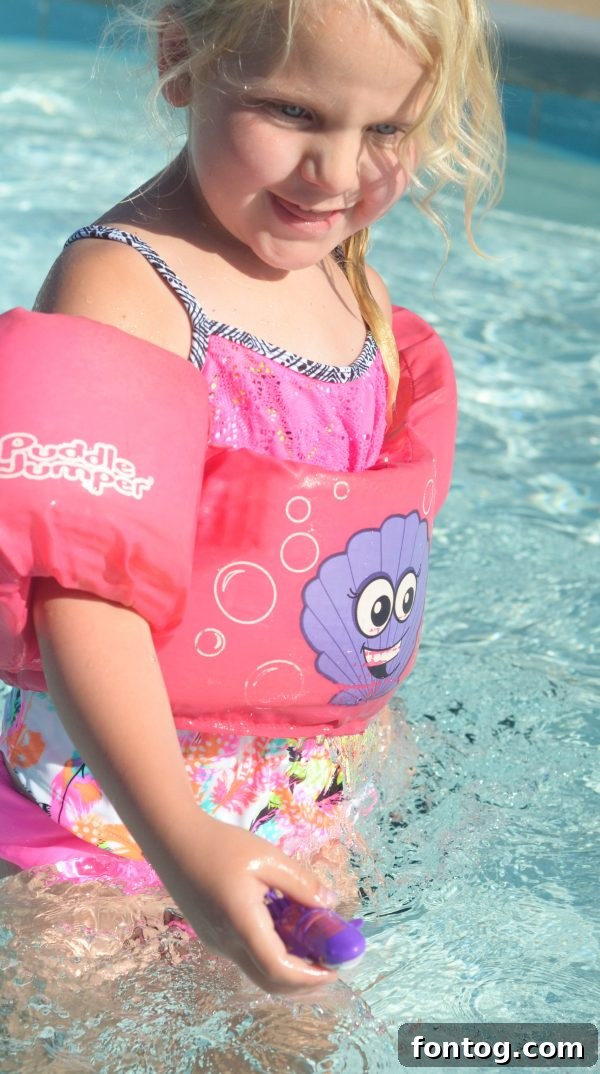 Multiple colorful Lil' Fishys swimming playfully in a backyard pool setting