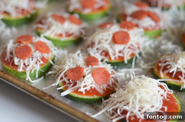 Close-up of freshly baked Zucchini Pizza Bites with melted cheese and mini pepperonis.