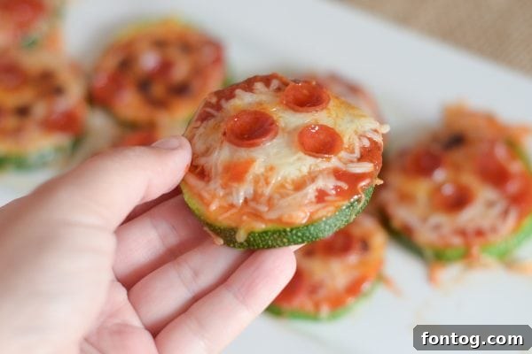 Baked Zucchini Pizza Bites on a baking sheet after broiling, cheese melted and slightly browned