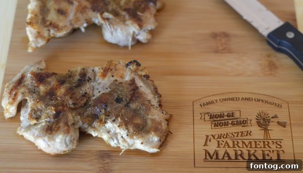 Blackened chicken cooking on a grill pan, ready for the Caesar salad