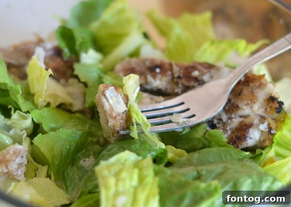 A serving of Blackened Chicken Caesar Salad with fresh ingredients