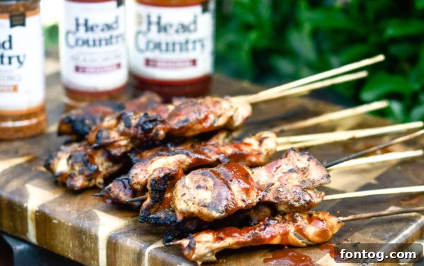 Tender Gluten-Free BBQ Chicken Kebabs 2 Perfectly grilled barbecue chicken skewers on a serving platter, garnished and ready for guests.