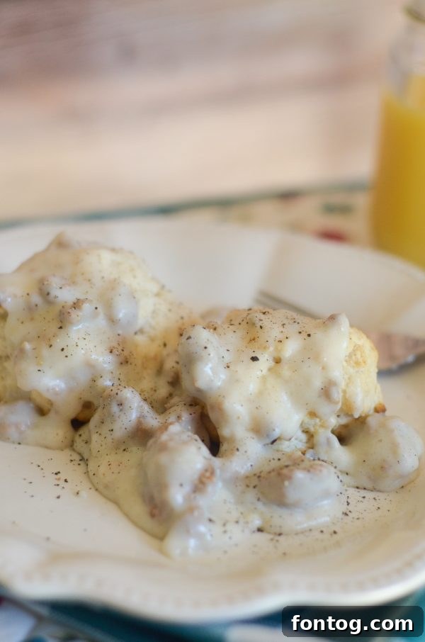 Hearty Gluten-Free Turkey Sausage Gravy served over golden biscuits on a rustic wooden table, ready for a comforting breakfast.