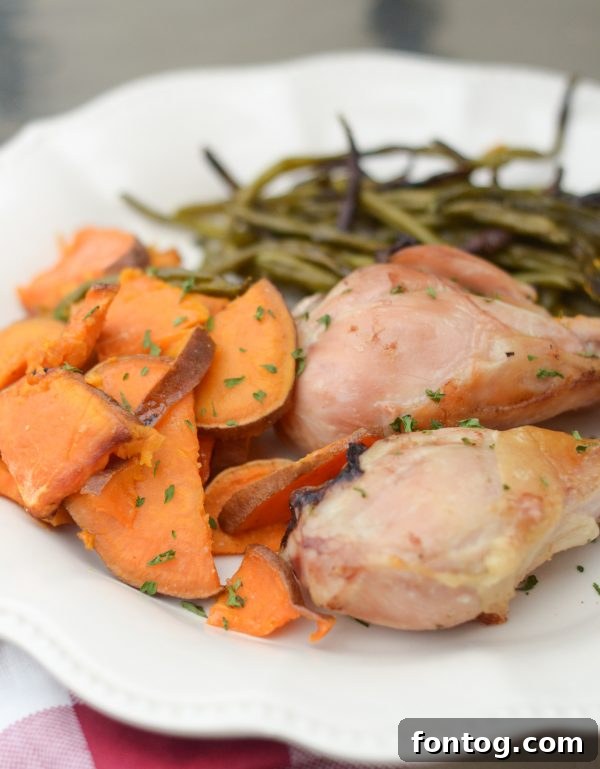 Crispy Sheet Pan Rosemary Chicken and roasted vegetables on a baking sheet, ready to serve, top view