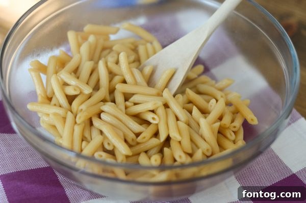 Overhead view of Chicken Salad Pasta Bowl ingredients on a rustic table.