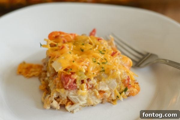 Unbaked King Ranch Chicken Casserole showing layers of chicken, creamy sauce, and Doritos
